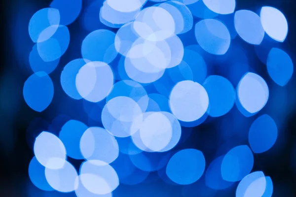 Blue defocused bokeh lights on black background — Stock Photo