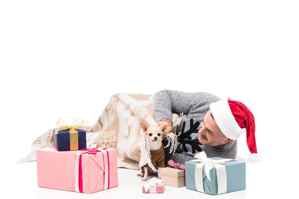 Happy man in santa claus hat with chihuahua dog and christmas gifts isolated on white — Stock Photo