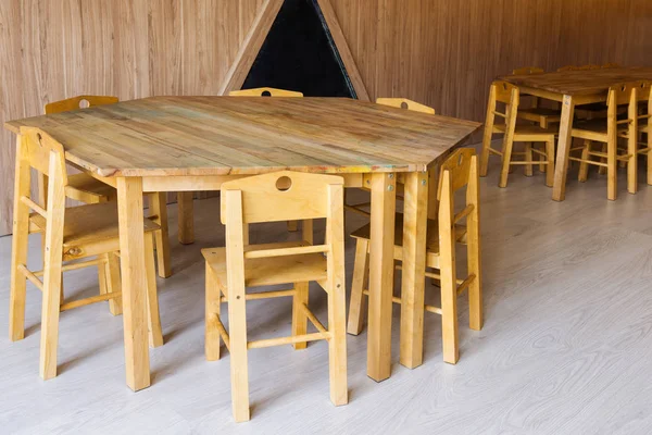 Wooden tables and small chairs in kindergarten room — Stock Photo