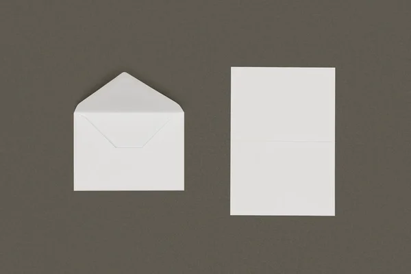 Top view of open white envelope and blank card isolated on grey background — Stock Photo