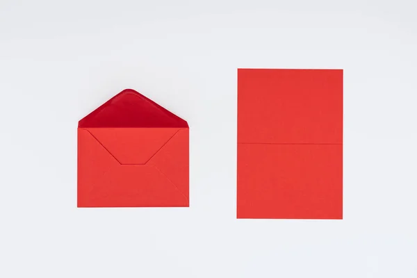 Close-up view of red envelope and card isolated on white — Stock Photo