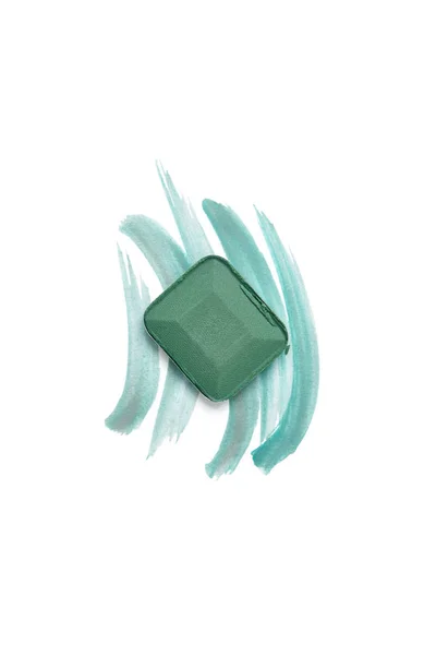 Top view of eyeshadow of green color with strokes on white background — Stock Photo