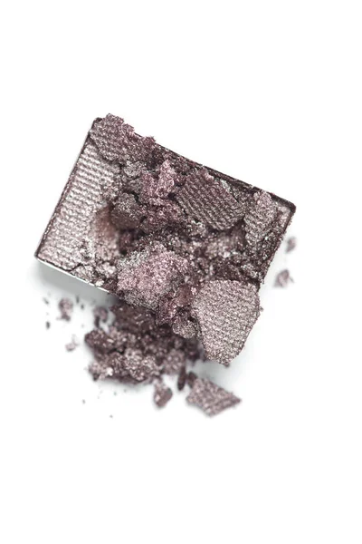 Top view of cracked grey eyeshadow on white backdrop — Stock Photo