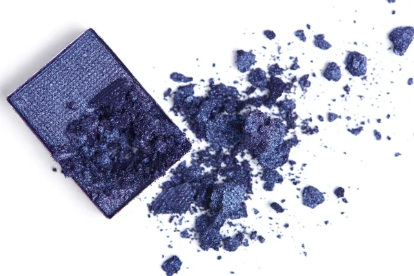 Top view of cracked blue eyeshadow on white backdrop — Stock Photo