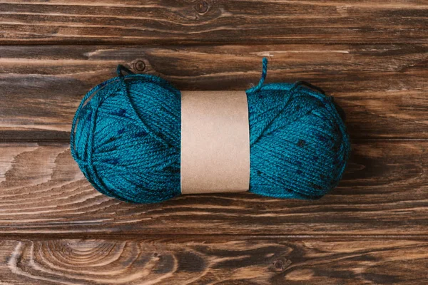 Top view of blue yarn clew for knitting on wooden surface — Stock Photo