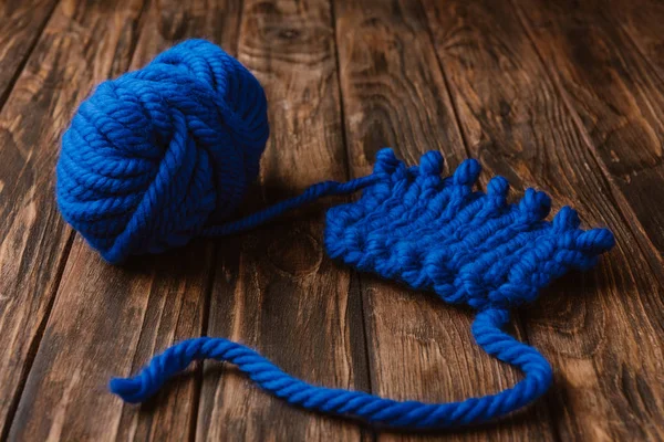 Close up view of blue yarn for knitting on wooden surface — Stock Photo