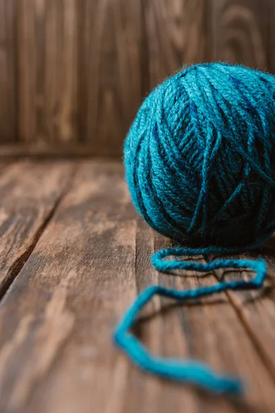Close up view of blue yarn clew on wooden tabletop — Stock Photo