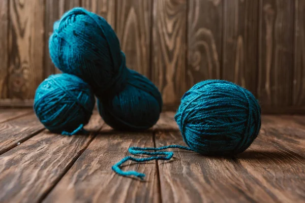 Vue rapprochée du fil bleu pour tricoter disposé sur une surface en bois — Photo de stock