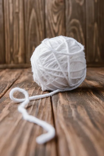 Close up view of white yarn clew on wooden surface — Stock Photo