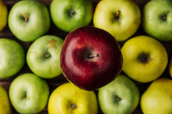 Top view of tasty red delicious apple with multicolored fruit at background — Stock Photo