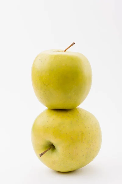 Stack of two ripe golden delicious apples on white background — Stock Photo