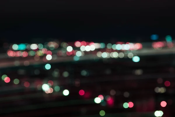 Blurred colorful bokeh lights at night — Stock Photo