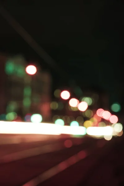 Blurred street with bright bokeh lights at night — Stock Photo