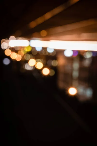 Blurred night background with bright bokeh lights — Stock Photo