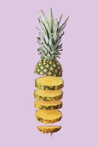 Sliced sweet organic pineapple isolated on purple — Stock Photo