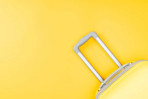 Top view of baggage with handle on yellow background — Stock Photo