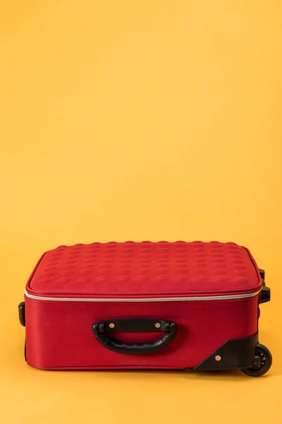 Travel bag with wheels on yellow background — Stock Photo