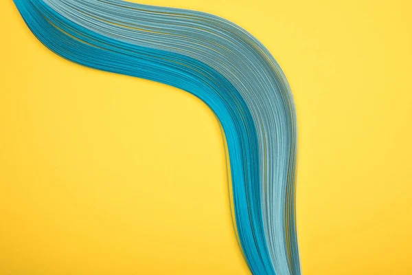 Top view of curved blue lines on yellow background — Stock Photo