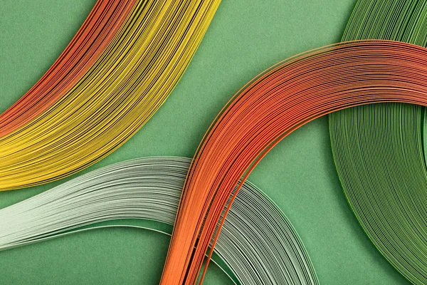 Close up of yellow, orange and green abstract lines on green background — Stock Photo