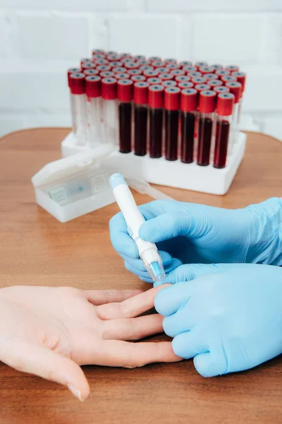 Cropped view of donor and doctor obtaining blood sample — Stock Photo