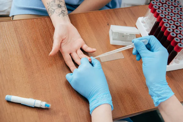 Cropped view of donor and doctor obtaining blood sample — Stock Photo