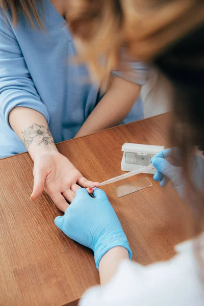 Cropped view of donor and doctor obtaining blood sample — Stock Photo