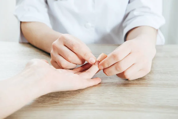 Partial view of donor and doctor using adhesive bandage — Stock Photo