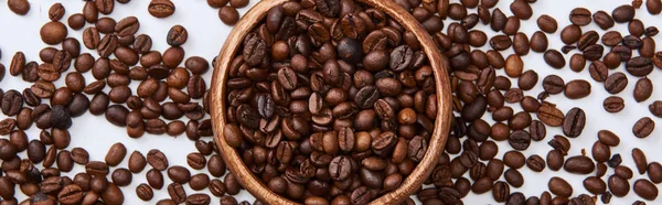 Panoramic shot of coffee roasted beans in wooden bowl on white background — Stock Photo