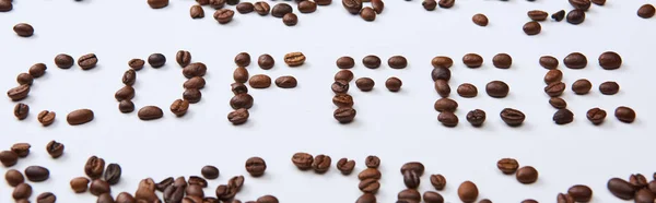 Colpo panoramico di lettering caffè fatto di chicchi di caffè su sfondo bianco — Foto stock