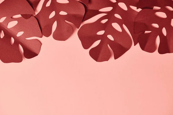 Top view of paper cut textured palm leaves on pink background — Stock Photo