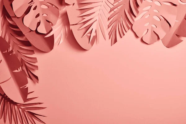 Top view of exotic paper cut palm leaves on pink background with copy space — Stock Photo