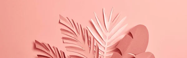 Bunch of paper cut palm leaves on pink background, panoramic shot — Stock Photo