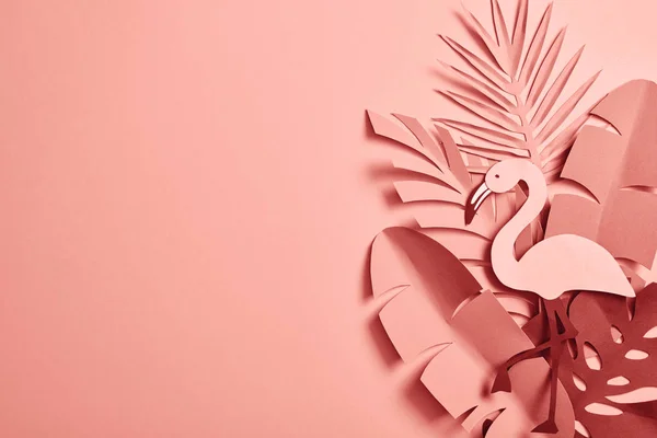 Top view of paper cut palm leaves and decorative flamingo on pink background with copy space — Stock Photo