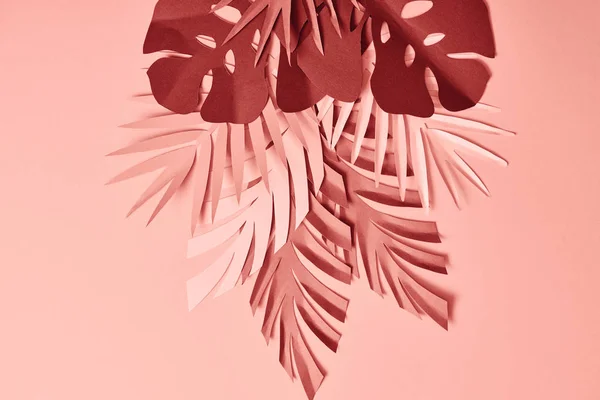 Bunch of colorful paper cut palm leaves on pink background — Stock Photo