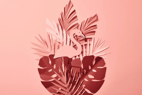 Top view of flamingo and paper cut palm leaves on pink background — Stock Photo