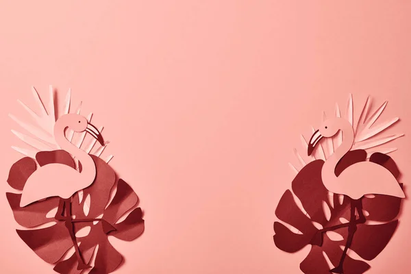 Top view of paper cut palm leaves and flamingos on pink background — Stock Photo