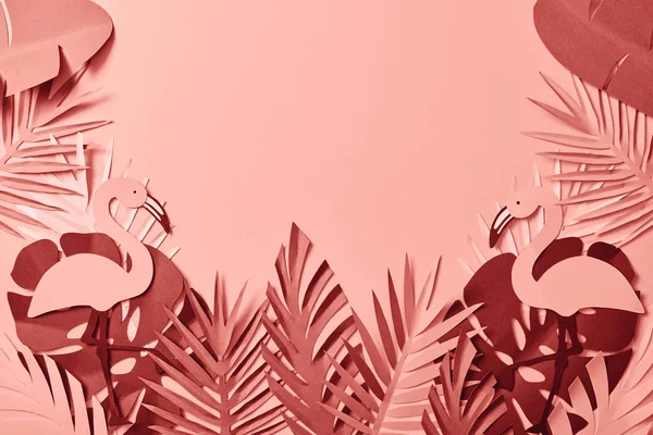 Top view of pink exotic paper cut palm leaves and flamingos on pink background with copy space — Stock Photo