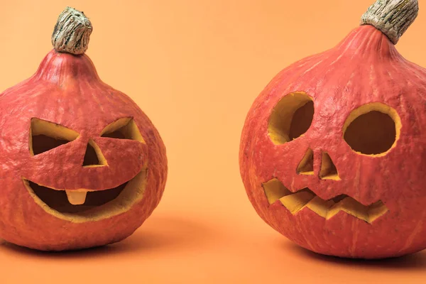 Spooky Halloween pumpkins on orange background — Stock Photo