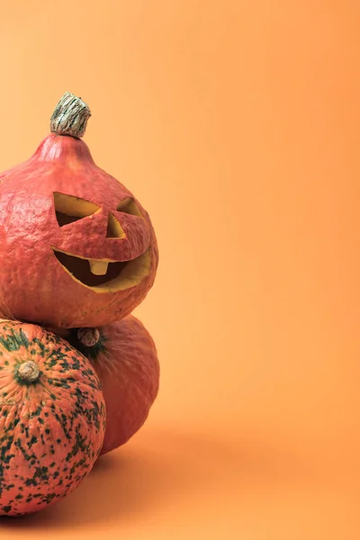 Spooky traditional Halloween pumpkins on orange background — Stock Photo