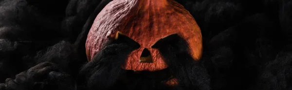 Panoramic shot of spooky carved Halloween pumpkin with black clouds — Stock Photo