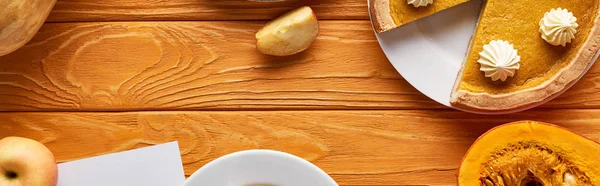 Вид зверху гарбузовий пиріг, стиглі яблука на дерев'яному столі, панорамний знімок — стокове фото
