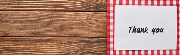 Top view of thank you card on wooden brown table with red plaid napkin, panoramic shot — Stock Photo