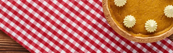 Top view of traditional pumpkin pie served at wooden table on red plaid napkin for Thanksgiving dinner, panoramic shot — Stock Photo