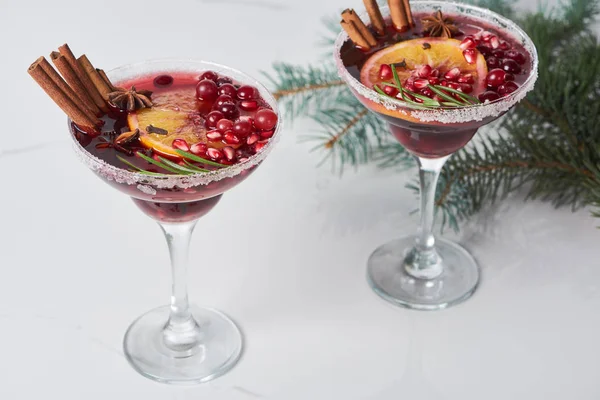 Christmas cocktails with orange, pomegranate and cinnamon — Stock Photo