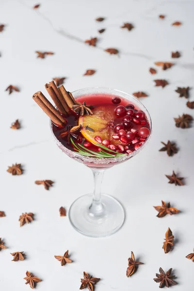 Selective focus of christmas cocktail with orange, pomegranate and cinnamon — Stock Photo