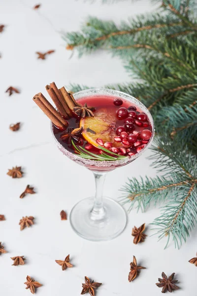 Selective focus of christmas cocktail with orange, pomegranate and cinnamon — Stock Photo
