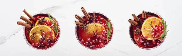 Panoramic shot of christmas cocktails with orange, pomegranate and cinnamon — Stock Photo