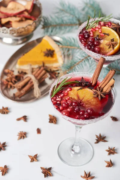 Selective focus of christmas cocktails with orange, pomegranate and cinnamon — Stock Photo