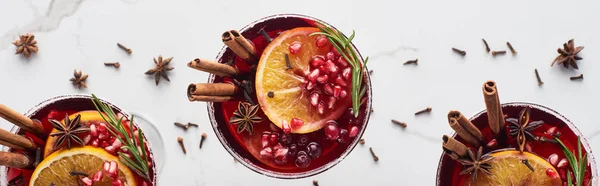 Panoramic shot of christmas cocktails with orange, pomegranate, cinnamon — Stock Photo
