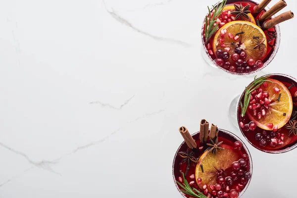 Top view of christmas cocktails with orange, pomegranate, cinnamon — Stock Photo